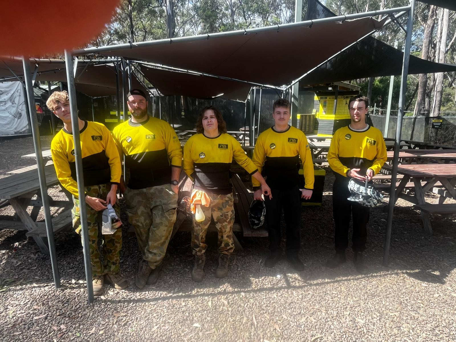 Five Delta Force marshals lined up in the outdoor operations area